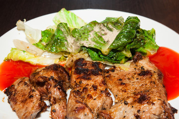 Grilled steaks, baked potatoes and vegetable salad