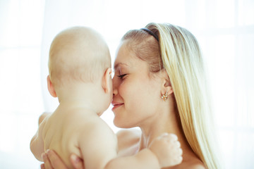 Mother touches her child's face tender