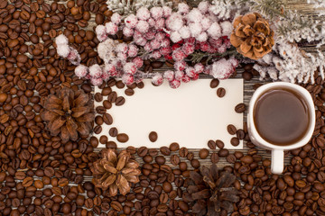 Cup of coffee,  beans, fir branch and blank for text on wooden background