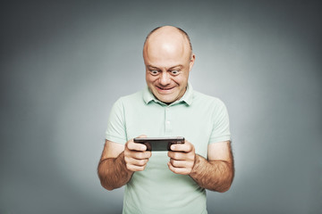 Middle-aged man looking at his mobile phone and he was surprised