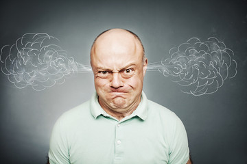 Closeup portrait of angry man, blowing steam coming out of ears,