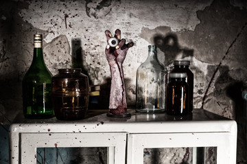 Dried up amputated hand with eyeball between glass jars in a Hal