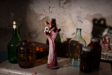 Wrinkled hand with eyeball between glass jars