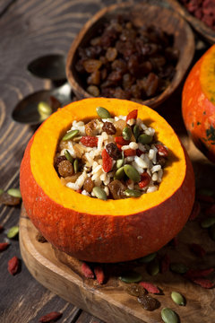 rice with dried fruit in a pumpkin, vertical top view