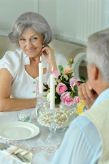Obraz na płótnie Canvas Happy elderly couple together having a dinner