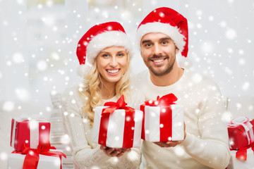 happy couple at home with christmas gift boxes
