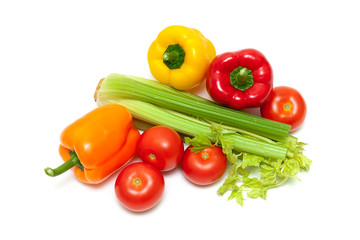 sweet bell peppers, tomatoes and celery on a white background