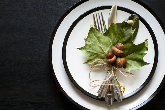 Autumn table setting on black wooden background. Top view