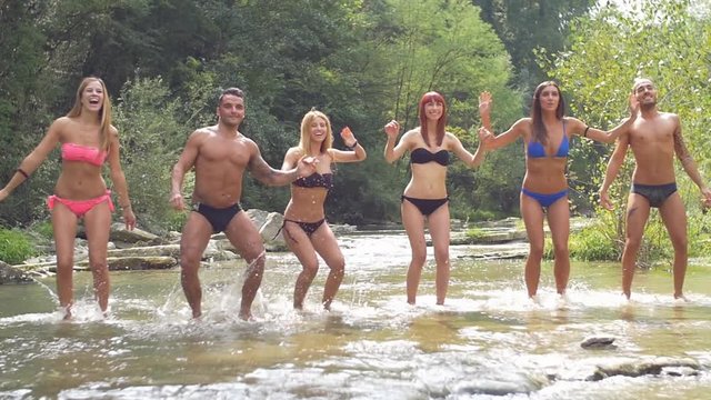 Group of friends have fun on the river
