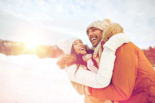 happy couple hugging outdoors in winter