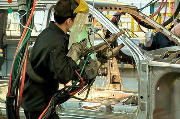 Cherkasy, Ukraine - May 29, 2012:Working welder at the plant for the production of cars.