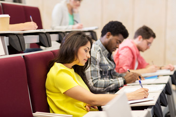 group of students with notebooks in lecture hall