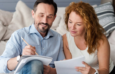 Middle-aged man and woman couple making notes