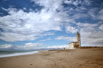 Sea and beach, long exposure shot, with a church