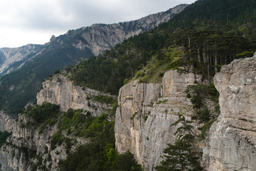 Rocky mountains cliff and blue sky with white clouds