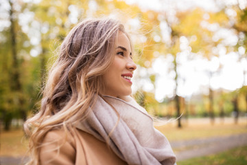 beautiful happy young woman smiling in autumn park