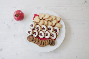collection of heart shaped biscuits or cookies served at home on a white plate