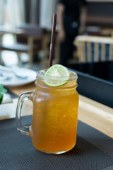 Ice tea with lemon sliced on table