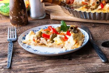 Greek tart with feta cheese and olives. Wooden rustic table