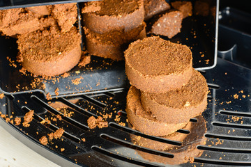 Compressed coffee grounds from the coffee machine