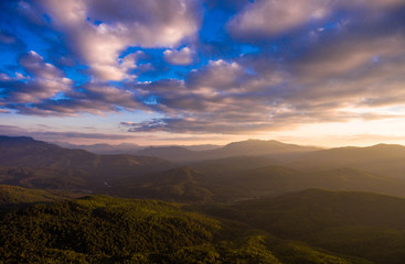 Fototapeta premium Mountain forest and cloudy dramatic sky in the evening.