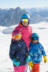 Fototapeta na wymiar Happy family enjoying winter vacations in mountains . Ski, Sun,Snow and fun.
