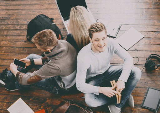 Tenagers studying on the floor in the university
