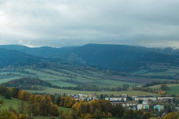 Seasonal landscape with morning fog in valley. Clouds drenched valley below the level of the mountains