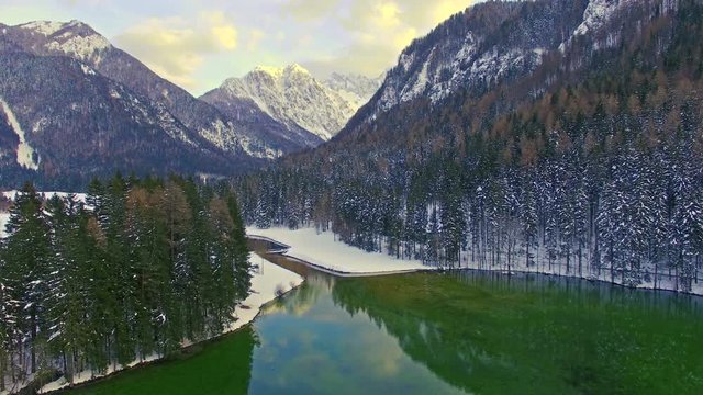 Aerial view of beautiful Jezersko Lake with mountain background on winter time