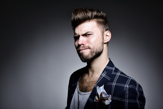 Portrait of handsome modern stylish man over gray background. Hy