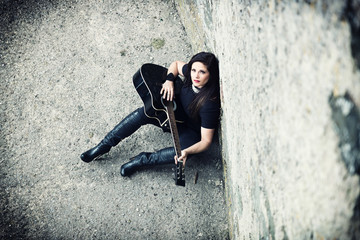 Looking down on sexy brunette with acoustic guitar