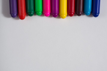 colored crayons and a sheet of paper, notebook concept creativit