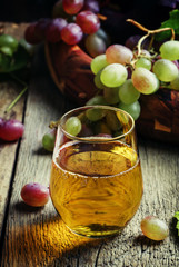 Light grape juice, still life in rustic style, vintage wooden ba