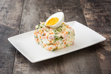 Russian salad on rustic wooden table

