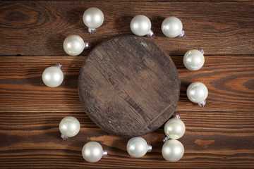 round wooden stand and christmas toys on wooden background conce