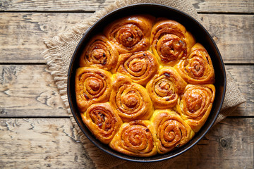 Cinnamon dough bun rolls spicy traditional Danish baked vegan sweet autumn cake holiday dessert swirl bread pastry food on vintage wooden table background