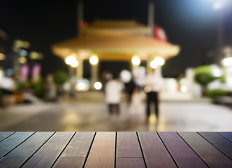 image of wooden table in front of abstract blurred background