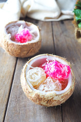 Close up of traditional asian steamed cassava cake with shredded coconut in a coconut shell. 