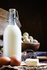 Fresh organic eggs, milk and butter, still life in rustic style,