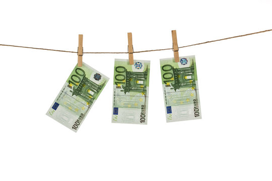 100 Euro banknotes hanging on clothesline on white background.