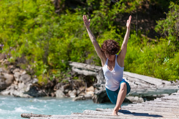 Woman is doing yoga excercises in Altai mountains