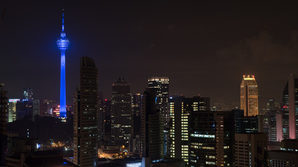 Plakat Kuala Lumpur at night, Malaysia. Illuminated city with luminous blue colored Menara KL Tower