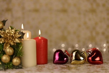 Christmas greeting card with tree, candles, lights and shinny hearts decorations.