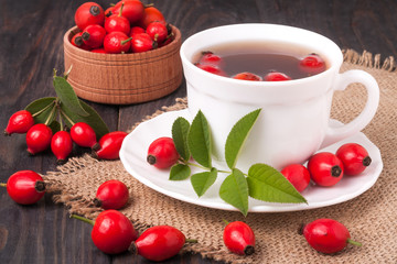 Tea from the hips on the wooden background