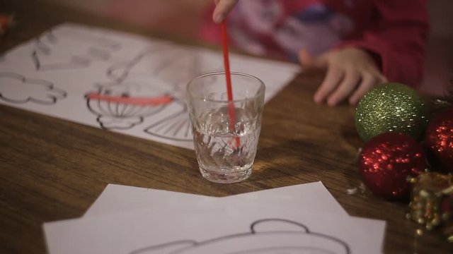 little girl draws a painting of Santa Claus. preschool child development