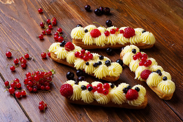 Eclairs on wooden table
