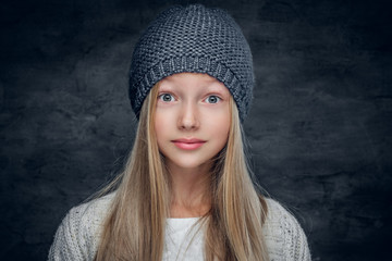 Blonde teenage girl in a warm winter hat