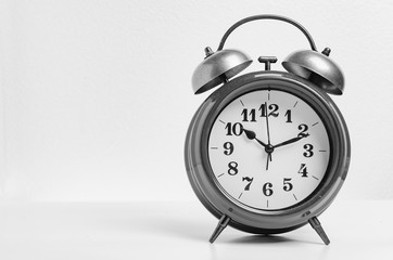 Retro alarm bell clock in black and white tone. Black and white object over white background.