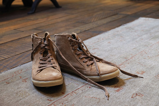 Vintage sneakers on the retro wooden and carpet floor - Soft focus