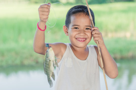 Little Boy Catching a Fish. Kids Fishing.